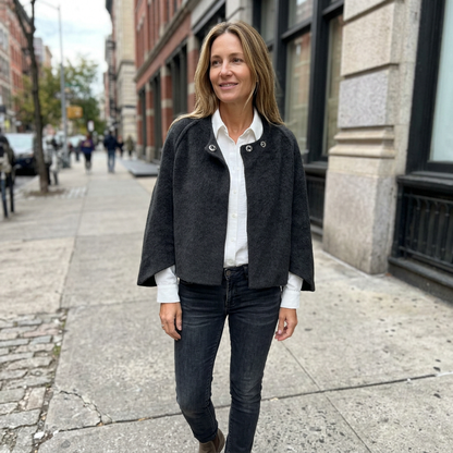 Sidewalk lifestyle photo of a European woman wearing the charcoal jacket